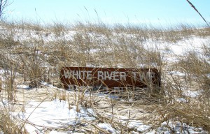 Dunes sign white river twp The buried sign is testament to the shifting sands of an active freshwater dune system at White River Township's sanctuary.