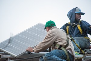 Solar installers on roof.