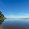 Lone walker on beach, still water_Tom Gill via Flickr